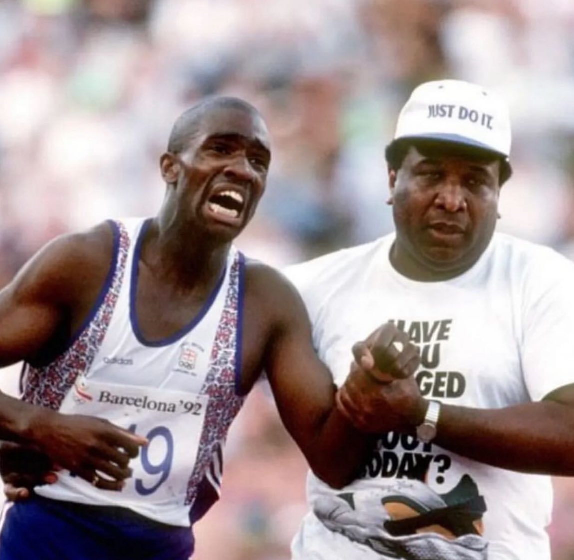 historyinmemes's tweet photo. An Olympian struggle: Derek Redmond and his Dad at the Barcelona Games, 1992.

At the 1992 Olympic Games, Great Britain's 400m runner Redmond suffered a heart-breaking injury in the semi-finals as his hamstring snapped. The injury occurred around the 250m mark and crashed to the floor alongside his Olympic dream.

The crowd started to clap and cheer him on. Meanwhile Derek Redmond's Dad managed to jink past officials and get onto the track and catch up with his son 120 metres from the finish line. I'm here, son" said Jim and he put his arm around his son. We'll finish together." Derek burst into tears but the two kept running, kept hobbling towards the finish line. 65,000 people cheered and clapped them on. A few feet from the line Jim let go of his son so Derek could cross the line on his own.

All of the 65,000 continued cheering and many wept as they were part of these very personal heart wrenching sporting moments.