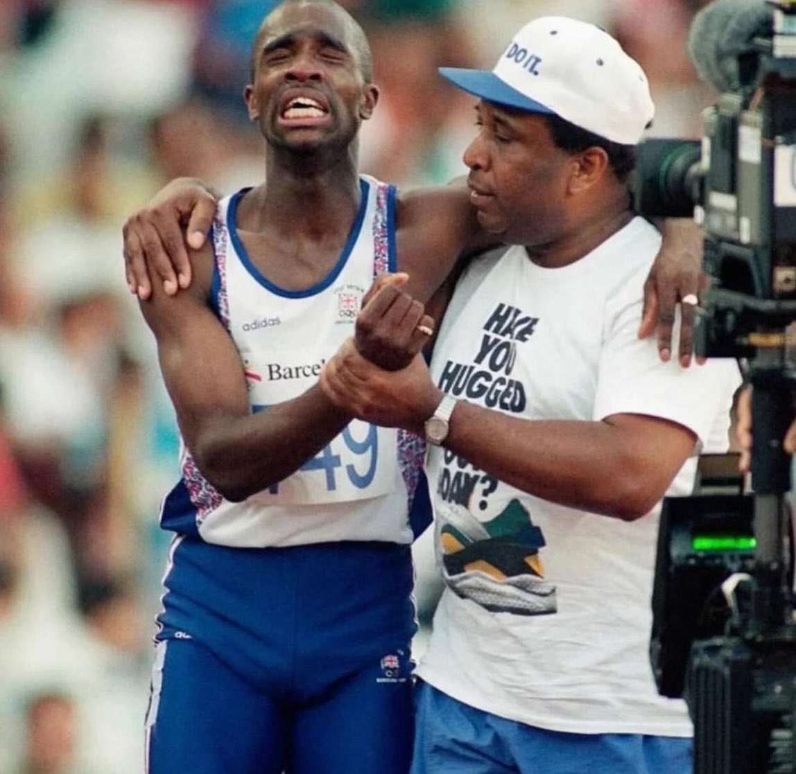 historyinmemes's tweet photo. An Olympian struggle: Derek Redmond and his Dad at the Barcelona Games, 1992.

At the 1992 Olympic Games, Great Britain's 400m runner Redmond suffered a heart-breaking injury in the semi-finals as his hamstring snapped. The injury occurred around the 250m mark and crashed to the floor alongside his Olympic dream.

The crowd started to clap and cheer him on. Meanwhile Derek Redmond's Dad managed to jink past officials and get onto the track and catch up with his son 120 metres from the finish line. I'm here, son" said Jim and he put his arm around his son. We'll finish together." Derek burst into tears but the two kept running, kept hobbling towards the finish line. 65,000 people cheered and clapped them on. A few feet from the line Jim let go of his son so Derek could cross the line on his own.

All of the 65,000 continued cheering and many wept as they were part of these very personal heart wrenching sporting moments.