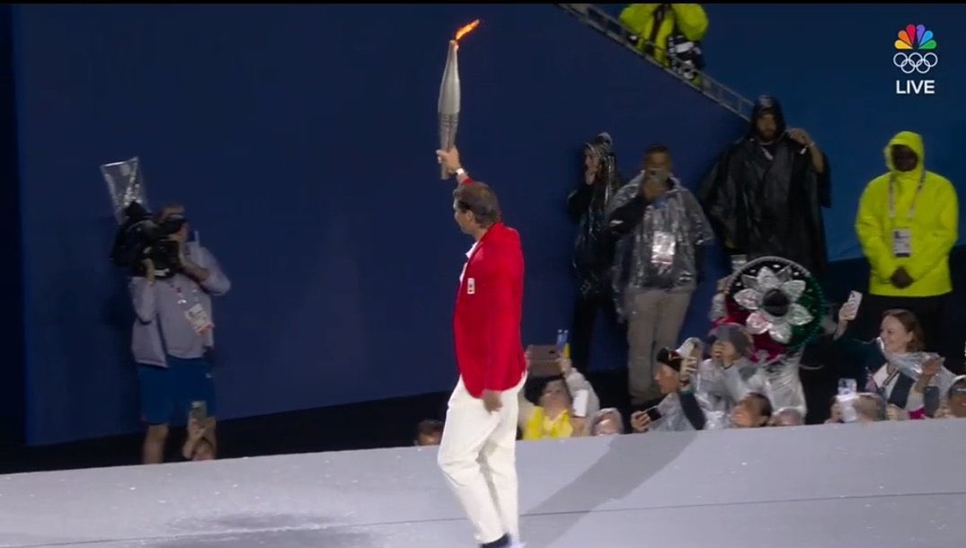 TheTennisLetter's tweet photo. Rafa Nadal carrying the torch at the Olympics Opening Ceremony. 

2-time Olympic gold medalist. 

Incredible athlete &amp; human being. 

So deserved. 🇪🇸🥹🔥 https://t.co/tK7Yhi5fX0