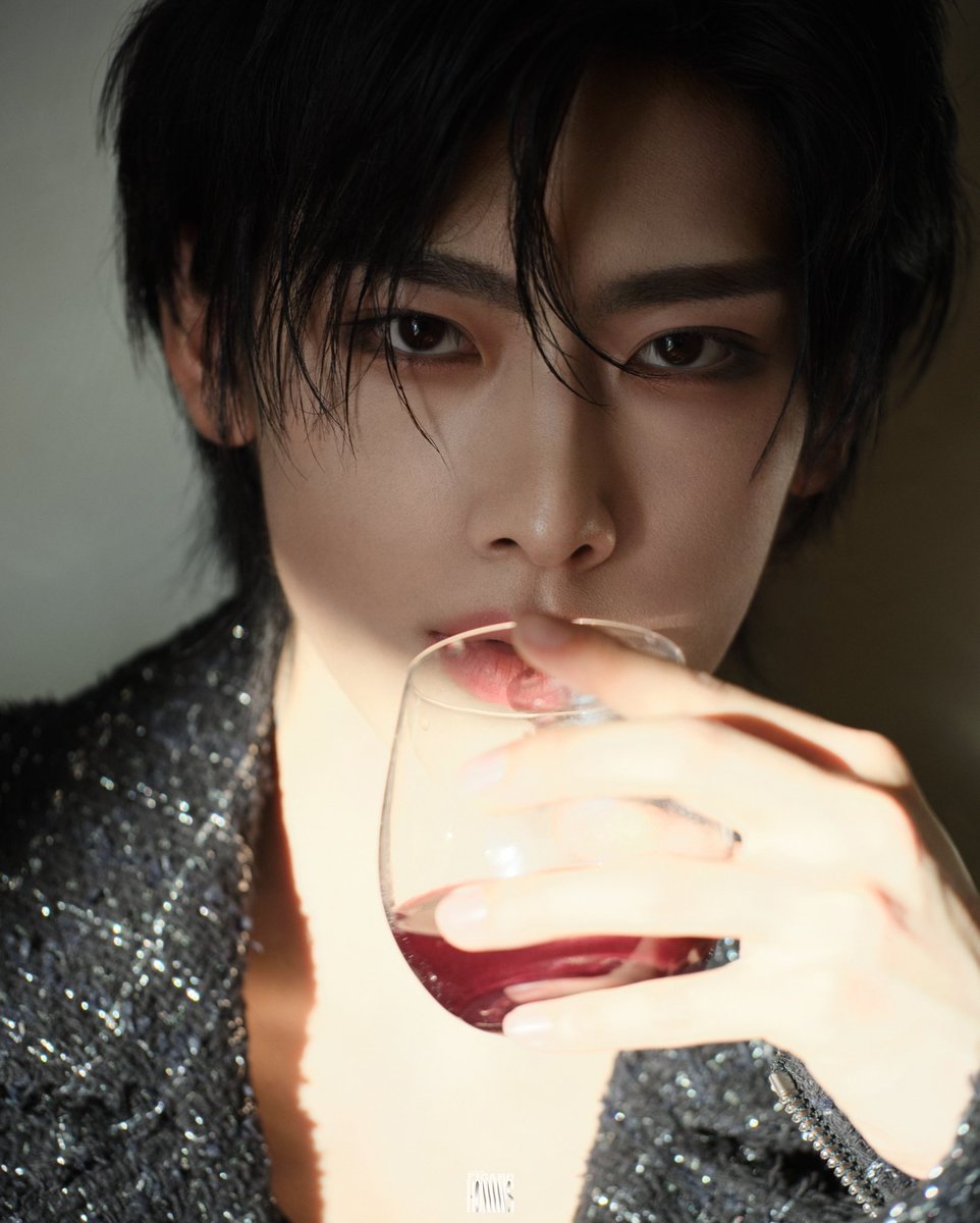 His eyes, twin beacons of intensity, lock onto the lens, piercing through the glass and into the soul of the viewer. The striking contrast between his dark hair and the softly lit background enhances the piercing quality of his eyes.