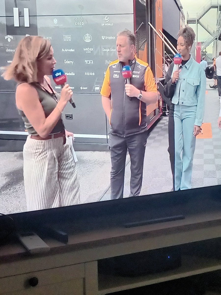 LukeDelmo's tweet image. Zak Brown looks very happy to see Natalie Pinkham!