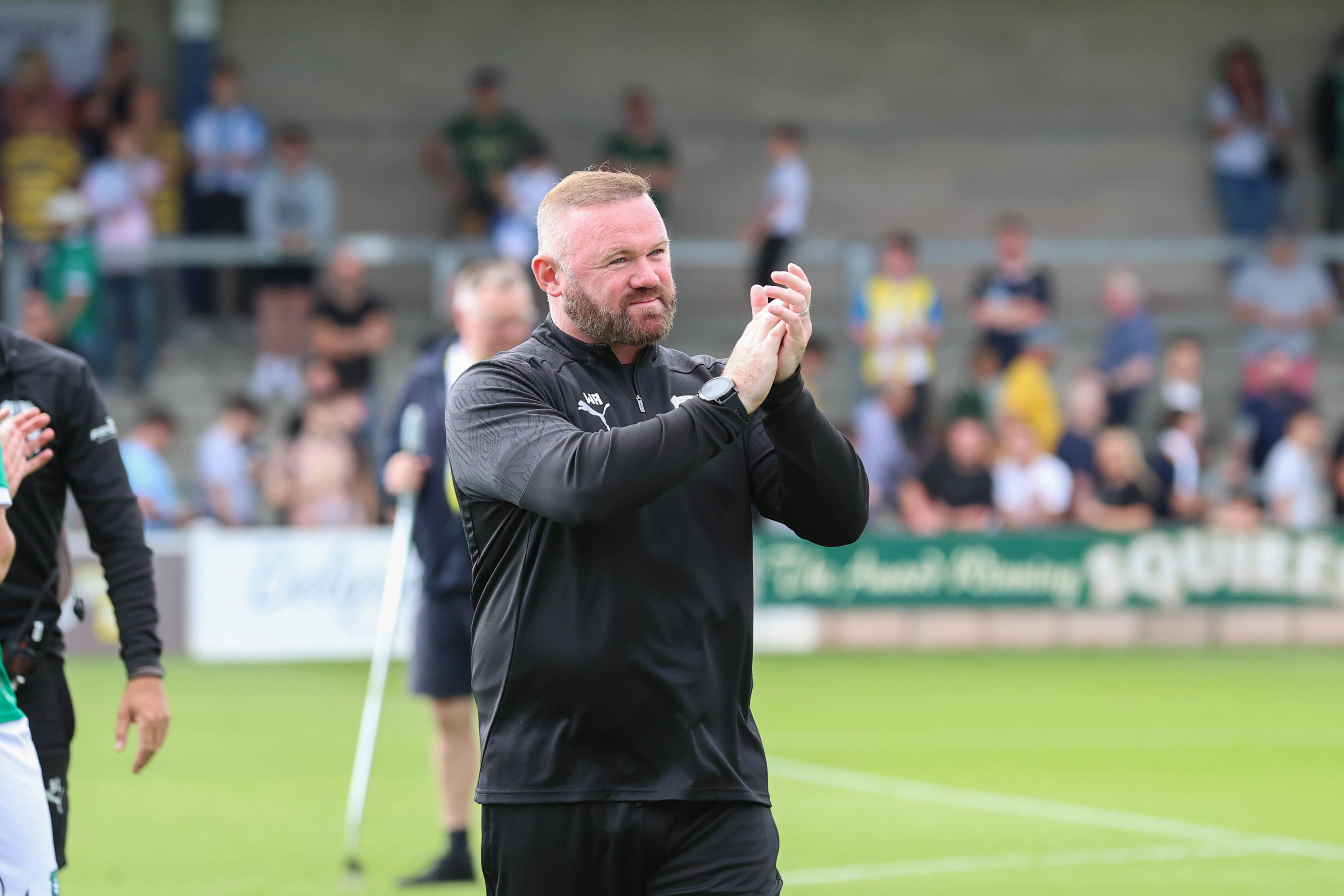 Wayne Rooney applauds the travelling Argyle fans.
