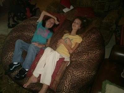 Picture of two disabled people lounging on a really big beanbag chair