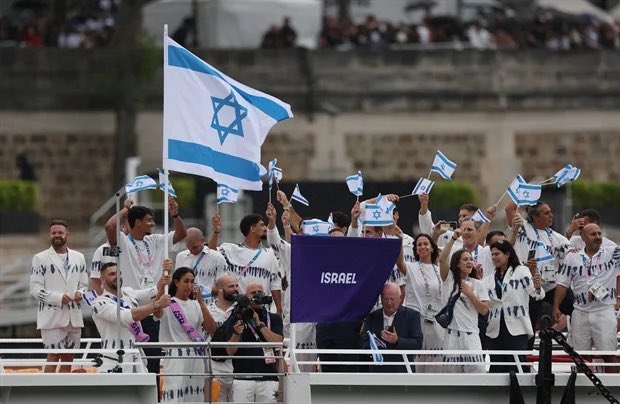 HenMazzig's tweet photo. Let’s take a look at the Olympics so far: 

- Israeli Olympic athletes Peter Paltchik and Meiron Cheruti received invitations to their own funerals ahead of the Paris Olympics via email.

- Israeli athletes have been victims of doxxing this week-end: hackers revealed their personal information on the Telegram network, including their passwords, blood test results, and more.

- Israeli athletes received death threats saying they would be murdered like in the 1972 Games in Munich.

- The Moroccan judoka refused to shake hands with Israeli judoka Baruch Shmailov after losing his match.

- Angry mobs were waiting for Israeli supporters after the Israel-Mali soccer game, leading to fights.

- The Israeli soccer team was protected by 1,000 police officers.

- Shin Bet agents are deployed in Paris to help protect the 88 Israeli athletes.

- A 15-year-old was arrested for planning a terror attack against President Isaac Herzog in Paris during the Games.

As Israeli committee chief Yael Arad said: "The athletes' first victory is that we're here." I couldn’t agree more 🇮🇱