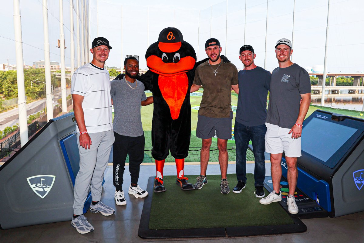 Ryan Mountcastle, Cedric Mullins, The Oriole Bird, Grayson Rodriguez, Jordan Westburg, and Ryan O'Hearn smile for a photo at Topgolf.