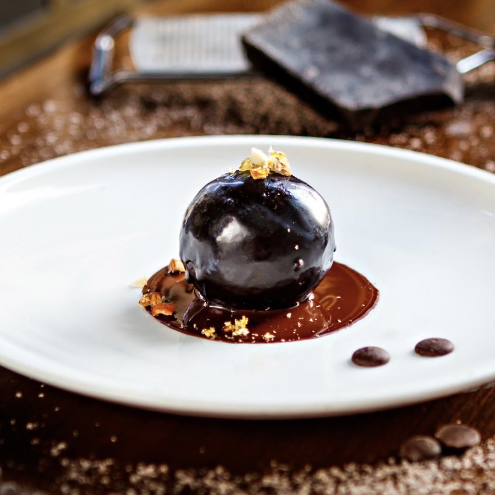 Indian_Accent's tweet photo. the rum ball at indian accent is made with old monk, a dark indian rum with a unique caramel flavor. the 70% valrhona chocolate elevates this dessert, adding a rich, deep cocoa intensity. we can’t get enough!
#indianaccent #newdelhi #inventiveindian https://t.co/RCSUDU5XFM