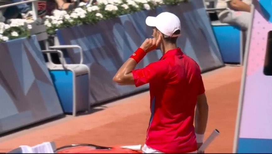 TheTennisLetter's tweet image. Novak Djokovic points to his ear as a sign to the crowd after breaking Rafa Nadal at the Olympics.