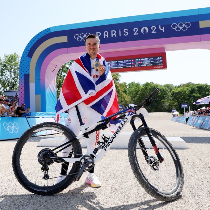Tom, his gold medal, and his bike.