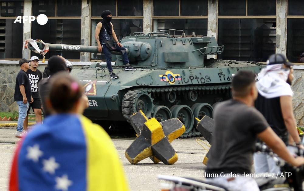 Demonstrators gather at the entrance of the 41st Armored Brigade, known as Paramacay Fort, during a protest against Venezuelan President Nicolas Maduro's government in Valencia, state of Carabobo, Venezuela
