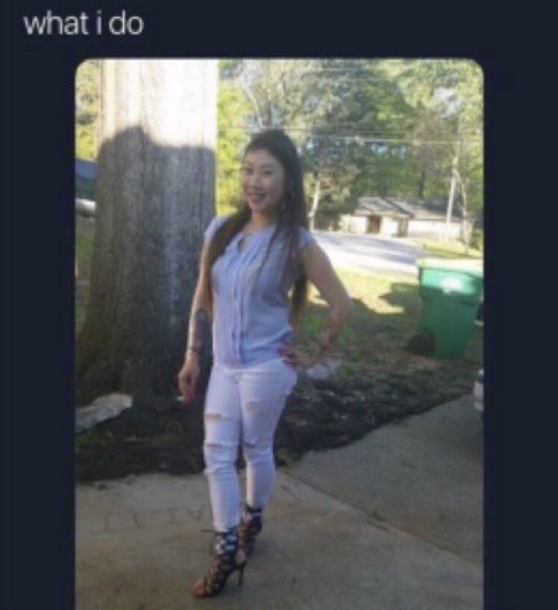 muglerize's tweet photo. ms. “what i do” lady wearing a pair of qupid lace-up heels while posing near a tree and trash bin (2022) https://t.co/oZVHDzHnUV