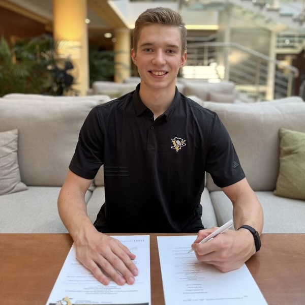 Photo of Sergei Murashov signing his entry-level contract.