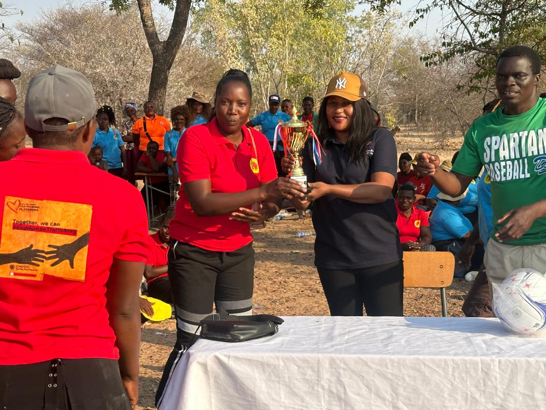 AnjinMining's tweet photo. Ms Tafadzwa Nyika from Anjin Investments (in brown cap) handing over a trophy to the winners of the Marange Women Alliance Anti Human Traffic netball tournament. https://t.co/lVkEDw8Ub6