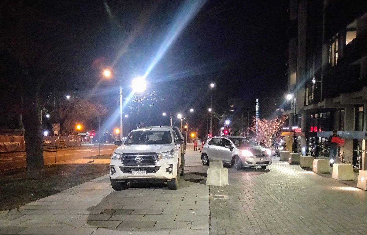 Amy_Jelacic's tweet photo. How much longer do we have to put up with vehicles parked on and driving along this major footpath on Eloura St in Braddon? Solutions are coming way too slowly. It feels like a big fuck you to everyone walking, cycling, and using the Eloura St light rail stop. https://t.co/CxC4oqueer