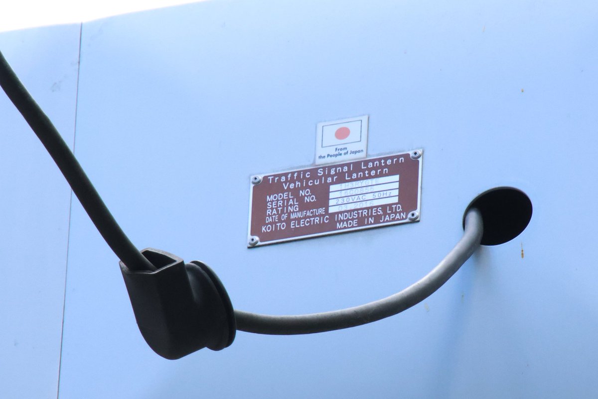 信号機の銘板。コイト電工製。 日本の支援で設置されたため、すべて