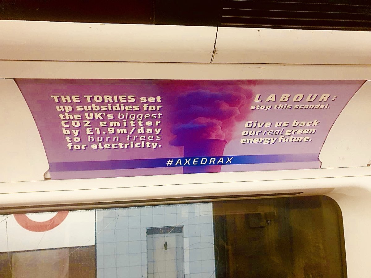 reclaimthepower's tweet photo. 📌 @axe_drax  Posters appeared across the London Underground last night reminding everyone that the Tories set up £1.9m/day subsidies for the UK's biggest CO2 emitter to BURN TREES.

🔥 Labour: stop the scandal, give us back our real green energy future and 🔥 #AxeDrax 🔥 https://t.co/i9u15DNHF7