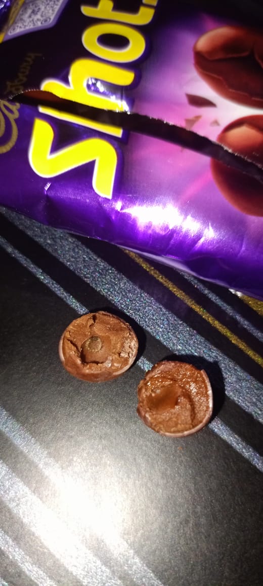 Navin12081997's tweet photo. Disgusted to find a bug in my Cadbury Dairy Milk Shots packet! 🤢 This is completely unacceptable. @DairyMilkIn @fssaiindia @MDLZ Please take immediate action. Your quality control is seriously questionable. #Cadbury #FoodSafety #Disappointed #Shocked #Unhygienic https://t.co/XIAUqwFQpI