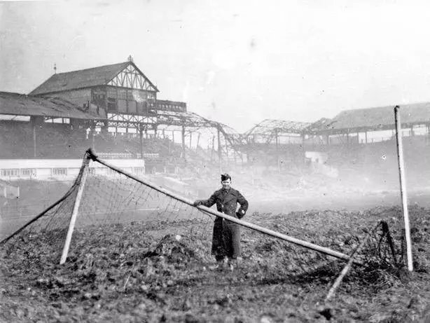 A lone soldier stands on the pitch at Bramall Lane following another night of bombing during the Blitz. (1940)