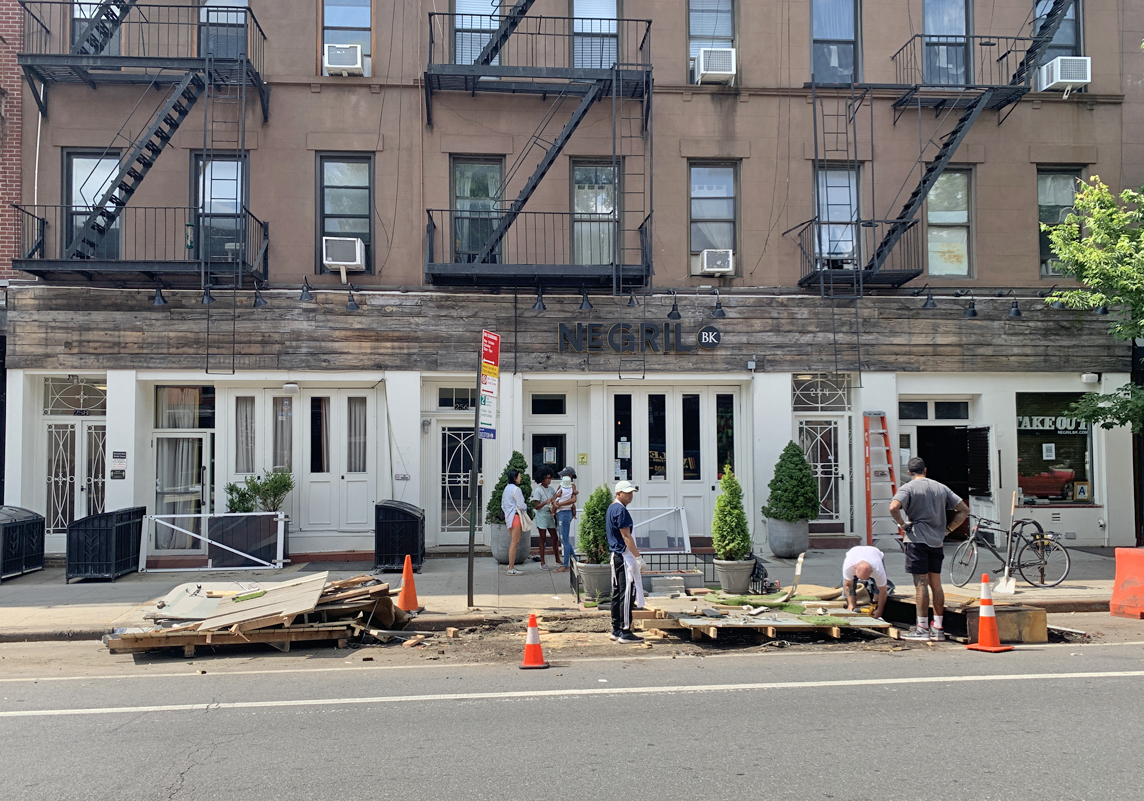 StreetsblogNYC's tweet image. The death of great public space continues as @NegrilBK demolishes its popular outdoor dining space (left in its heyday). Coming soon: space for stored cars that do no good for the public at all.