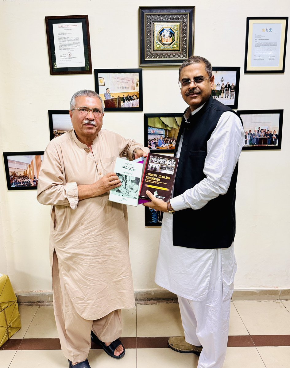 Former Dean of QAU, Prof. Dr. Syed WAQAR Ali Shah presenting his books to Library of Department of History &amp; Pakistan Studies through its Chairman Prof. Dr. Mahboob Hussain