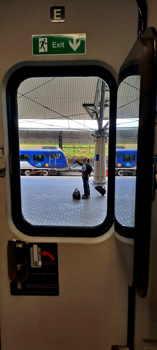 Guard_Amos's tweet photo. Today's view from the @northernassist #mobileoffice is something a but different. A couple of passengers check the platform screens for their train at @manairport as a #caf331 stands in background with a service for @NetworkRailLIV https://t.co/P5jW3KfCao