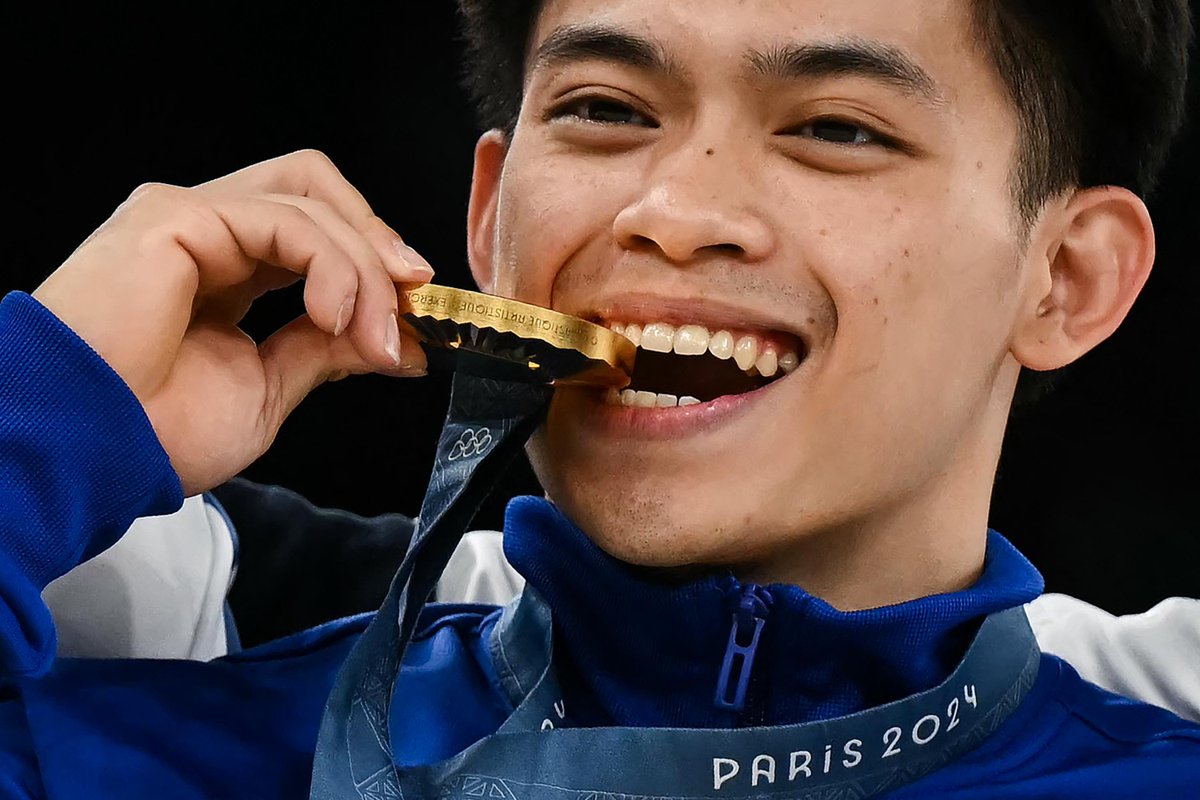 inquirersports's tweet photo. LOOK: Carlos Yulo poses with his medal and pauses for the national anthem of the Philippines as he stands on the podium after winning the gold medal during the men's artistic gymnastics individual floor finals. #Paris2024 | 📷: Seco/AP; Bonaventure, Ellis/AFP https://t.co/zM86lA3Idn