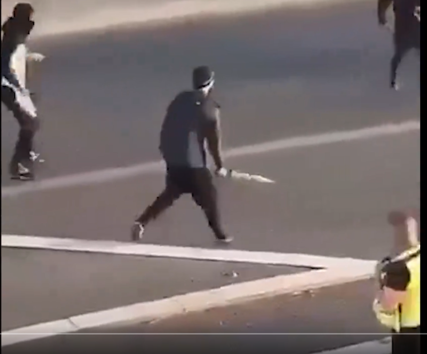 Two-tier policing!! 
This idiot migrant with some kinda sword and the policeman (seen in pic) simply does absolutely nothing and sort of walks away!! (min. 00:26)
#FarRightThugsUnite