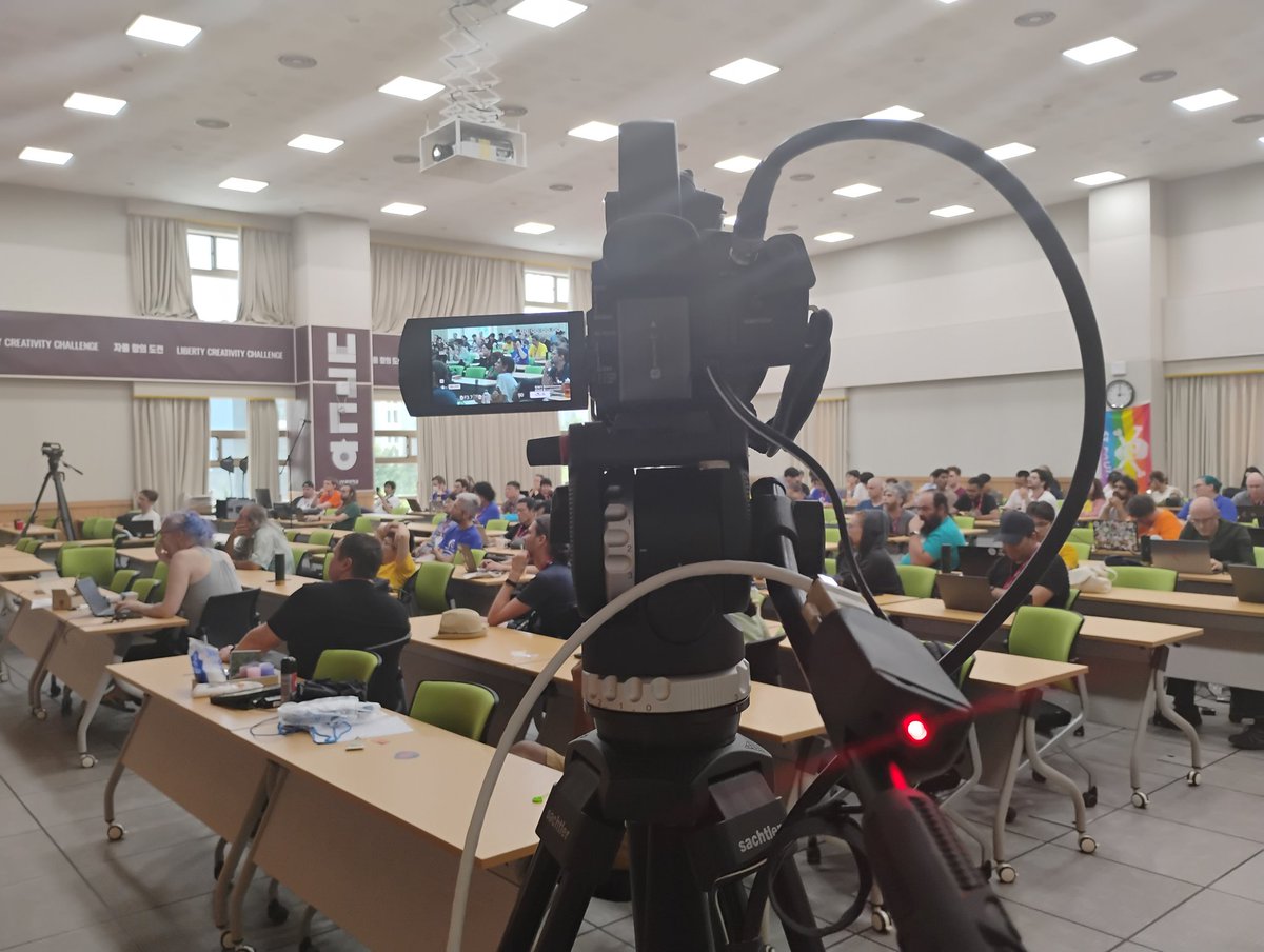 SubinSiby's tweet photo. Did a volunteering of camera work at #DebConf24. It's just like the livestream setup you see in a sports match stadium. When camera is on live, red light blinks.

The livestream video setup stack is all FOSS, the red light is controlled by ethernet. Voctomix is the software https://t.co/s2Vhu4YOOm