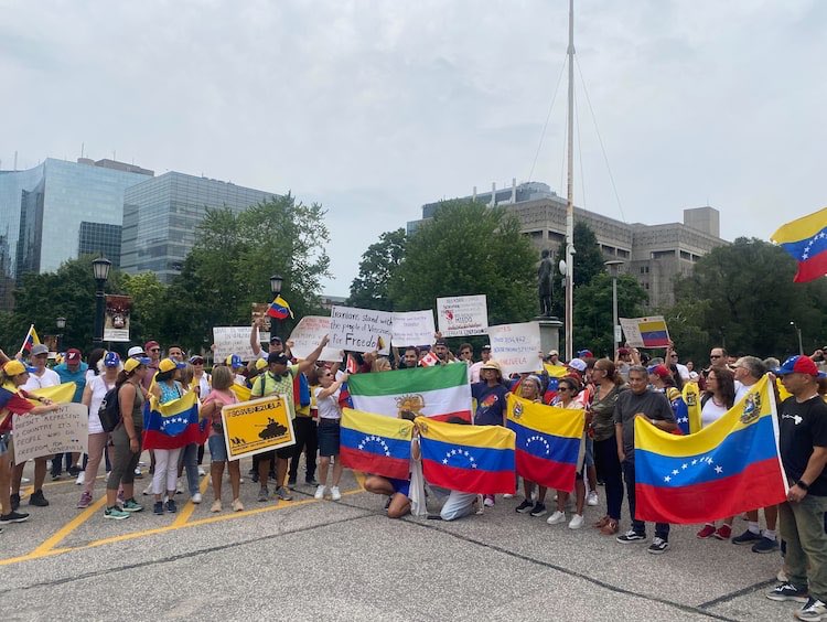 acoyne's tweet photo. Protesters in downtown Toronto demand stronger Canadian response to ‘rigged’ Venezuelan election https://t.co/T57xuNMvBt https://t.co/JstDMWzQSe