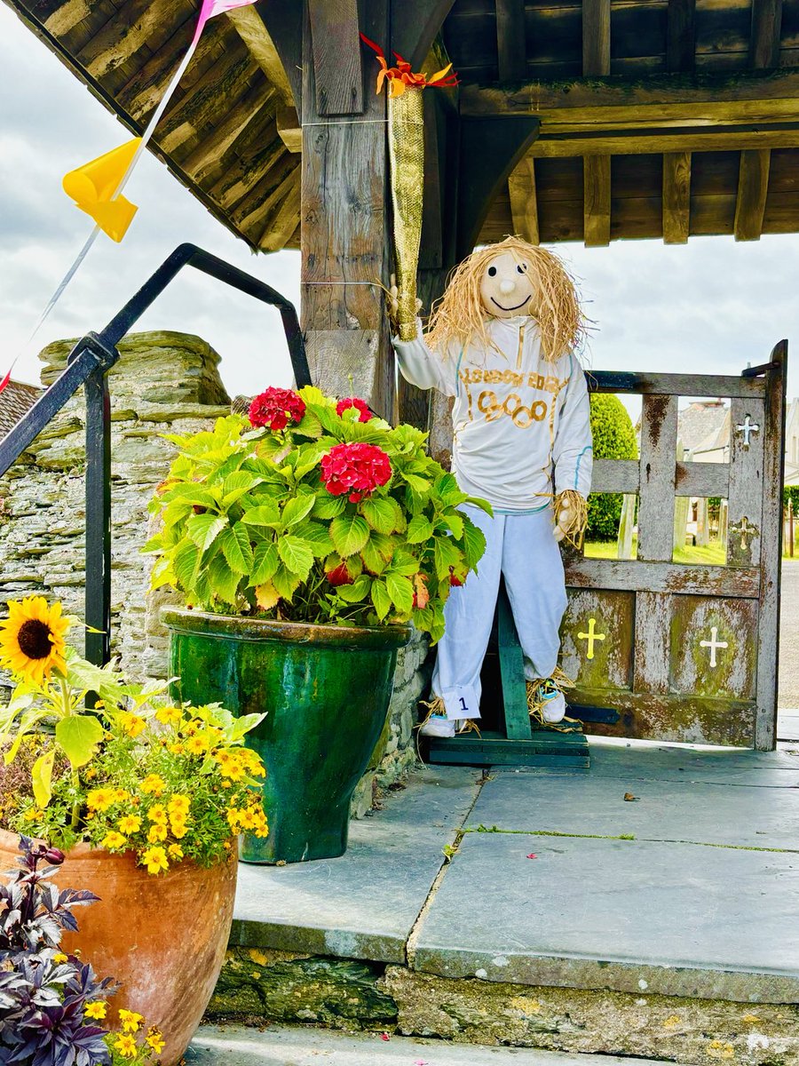 helenpgarlick's tweet photo. Let the Mortehoe Scarecrow Olympics begin! Entry number 1 carrying the torch flame by the porch leading to the church!! Lovely day for it and the crowds are already building! 💙 https://t.co/BXYGMqmEFA