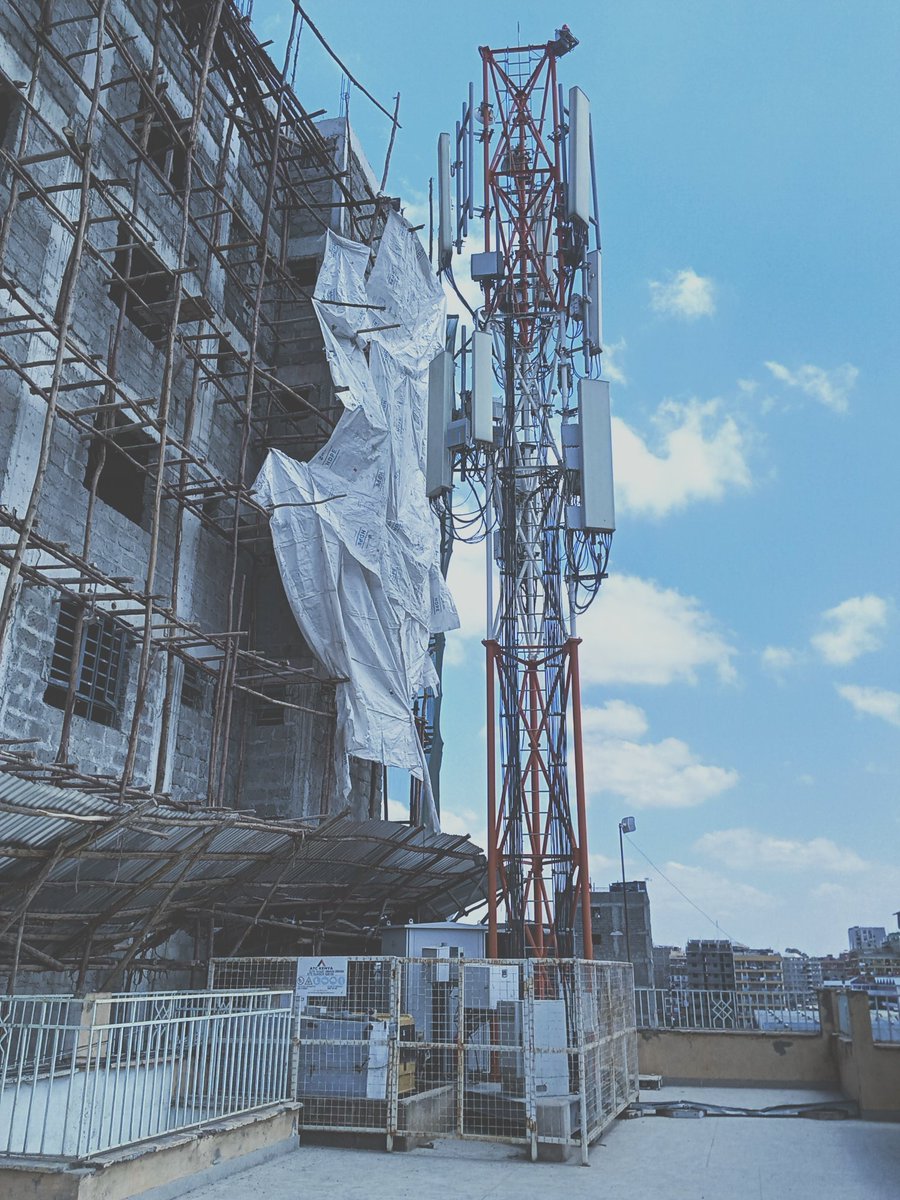 Reccudo's tweet photo. @ncakenya A new apartment complex is currently under construction adjacent to a building that features a rooftop communications mast. Will the residents living in proximity to the mast be exposed to radiation? Is this safe/permissible? cc @knrakenya @CA_Kenya https://t.co/GeeztDbc4J