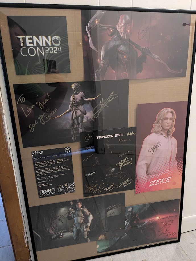 Glitchesarecool's tweet photo. Finally getting around to unpacking and putting up our #tennocon2024 stuff, loved getting everyone's signatures on @irisillych 's poster. Need to find some black backing fabric, but this is good enough for now to keep that all safe. https://t.co/S9Ejddf1GF