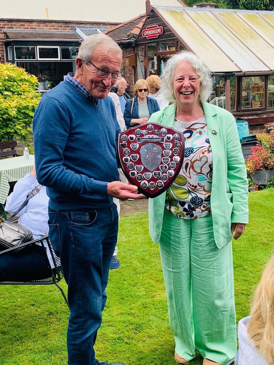 Tony is a hard working volunteer in the local community and a member of our club . He is being presented with last years attendance award by Roxanne .