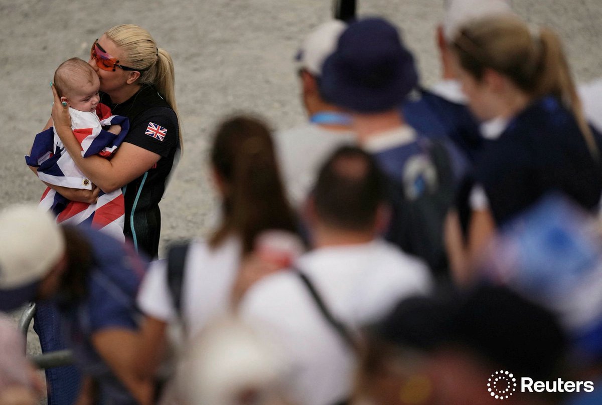 #Paris2024 Olympics - Shooting - Skeet Women's Final - Chateauroux Shooting Centre, Deols, France - August 04, 2024. Silver medallist Amber Jo Rutter of Britain kisses her son. — <a href="/Reuters/">Reuters</a> / <a href="/ReutersSports/">Reuters Sports</a>