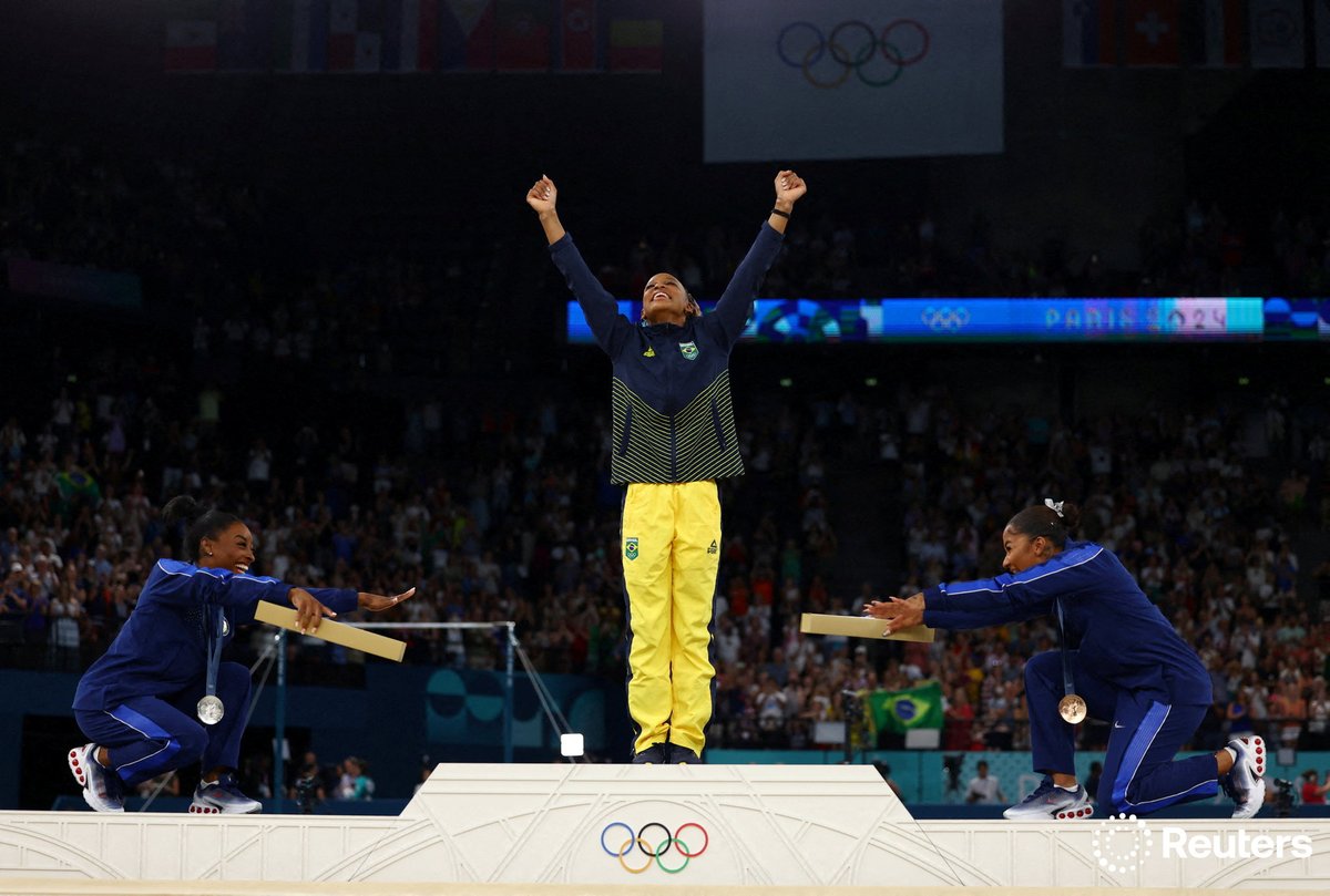U.S. gymnasts Simone Biles and Jordan Chiles bow down to Brazil’s Rebeca Andrade, who won the gold for the individual floor exercise final, during their #Paris2024 #Olympic medal ceremony. Biles won silver and Chiles won bronze. reut.rs/3AkOcmI  📷 Hannah Mckay