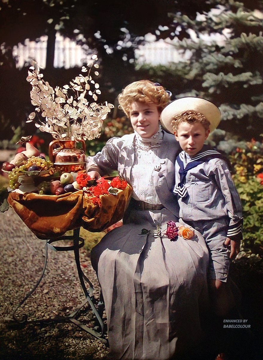 An Edwardian mother and child, photographed in colour 114 years ago. I've enhanced for you this charming autochrome from around 1910, that peculiar moment in history when dressing up as a sailor was height of social conformity for well-heeled boys.
The photo is original colour