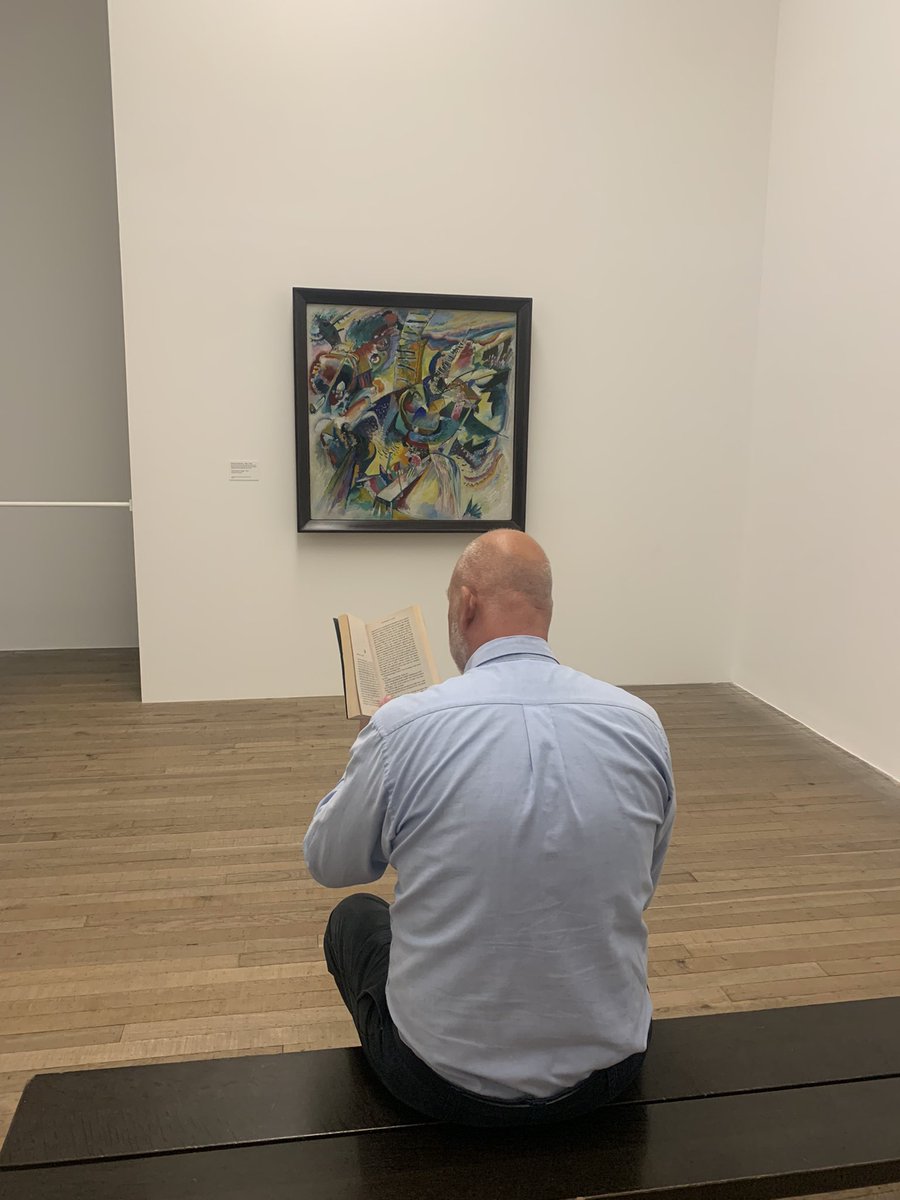 SandwichJunior's tweet photo. Mr Dyson reading ‘Somewhere Arty’ @Tate in front of Wassily Kandinsky’s Improvisation Gorge #SJSSummerReadingChallenge reading Different Class @Joannechocolat https://t.co/U1iEG95VxG