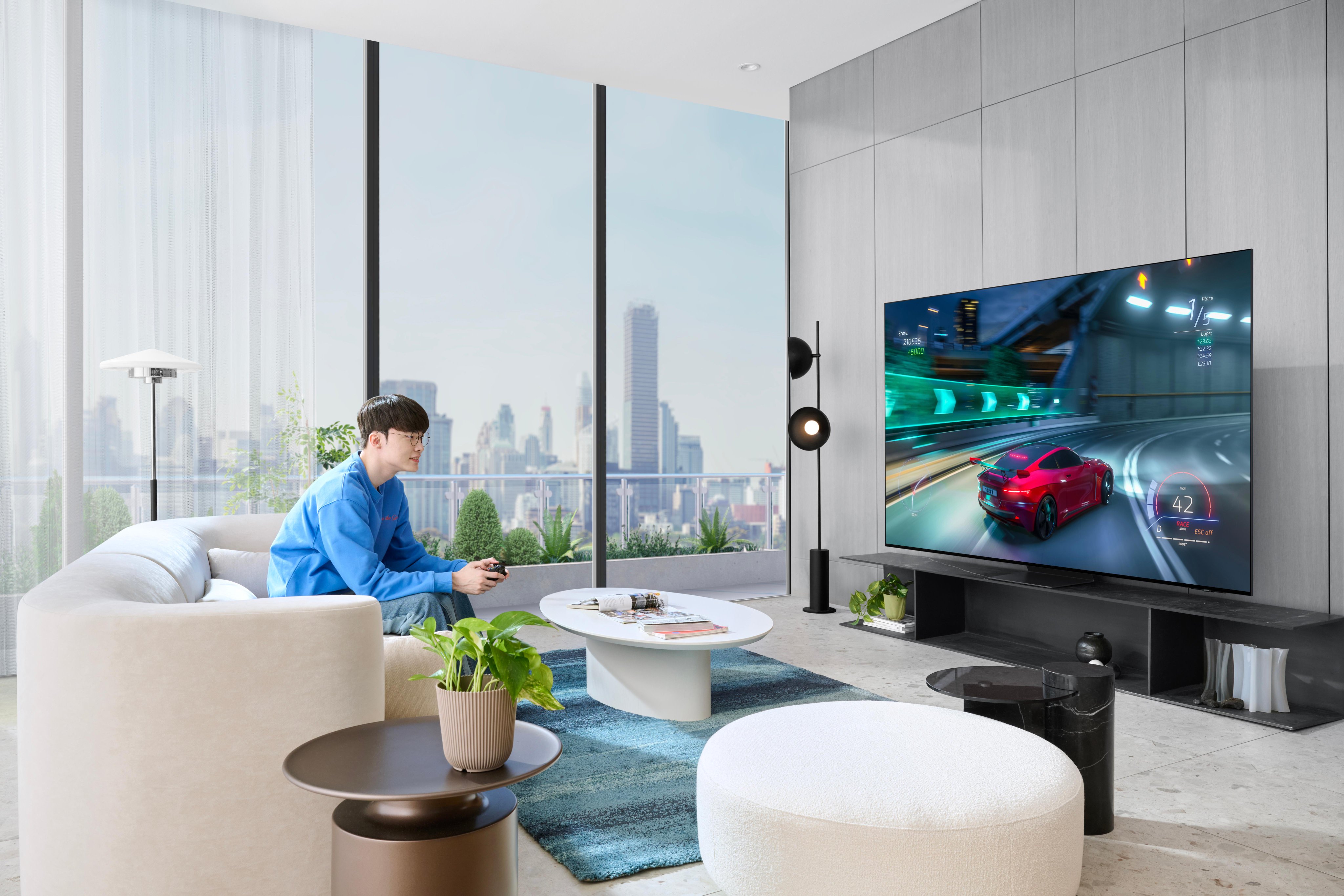 At the same room, Faker is playing a racing game with a joystick.