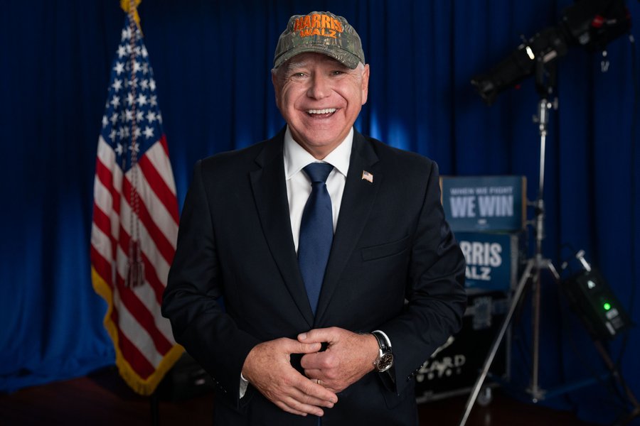 Governor Tim Walz wears a Harris Walz camo hat.