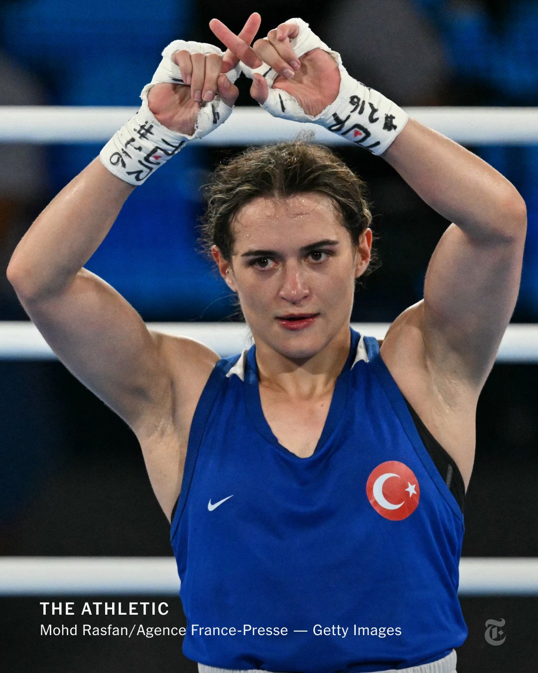 Turkey's Esra Yildiz Kahraman reacts after losing to Taiwan's Lin Yu-ting, making an an X symbol with her index fingers.