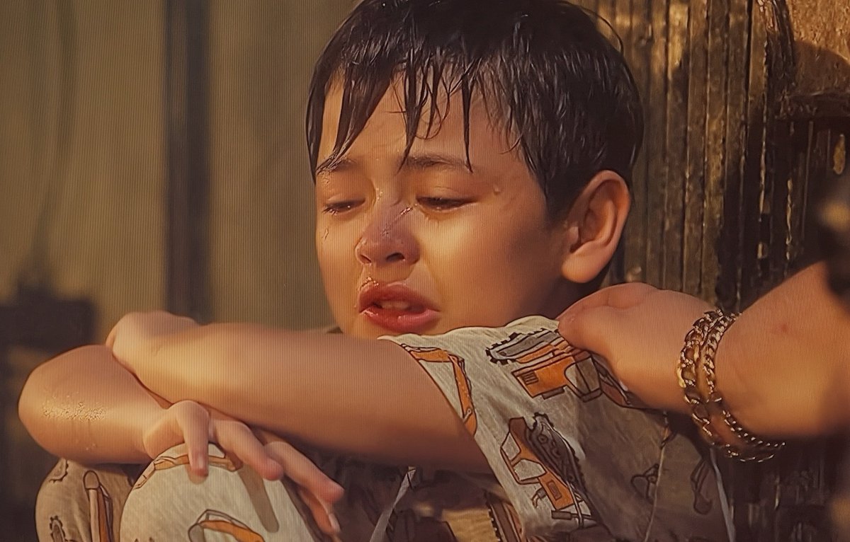 AltheyuhMoves's tweet photo. A Feel-Good Tearjerker #LoloAndTheKid 

The Netflix film started off like Adam Sandler’s Big Daddy or the indie, Lawn Dogs. A comedy about an unlikely duo; a smart- mouth kid and a crook of a father-figure or in this case a Lolo.  
Comedy?
Not when I found myself blinking back tears.

The story is pretty simple.  It is about an old conman (played by the brilliant Joel Torre) and his adopted child, Kid (The child wonder from Firefly, Euwenn Mikael Aleta) who became his literal partner in crime.  They are a pair of swindlers, duping a bunch of childless parents in an elaborate modus.  

Honestly, at first…. I did not know what to feel.  Watching them go from one crime to the next, it was at first hard to find empathy for the characters.  It just felt like uproarious shenanigans and crude humor. 

But soon, the film wins you over as it becomes more earnest of the human condition.  Of what unconditional love can really mean.  Once Joel Torre’s Lolo character tells us the fairy tale of the evil king and the little prince, I found my heart softening. 

The film is extremely well-acted, with cameos of amazing actors.  

The lead, Joel Torre gives a heartfelt and gutting performance as Lolo Mario.  I love how he wins as over in the film, how at one point we see him as an obnoxious ass to really just a loving lolo.  

Euwenn is such a natural in the role, he made Kid very real to me.

And watch out for Juan Karlos’ role too, totally etched and made a poignant mark on the film.

The beauty of the film is in its sentimentality and directness.  The simplicity of it all.  Benedict Mique who is more known for his tv project, the controversial Darna —- understands that the real emotions come from the simplest human experiences and our sacrifices for love.  It is fast-paced and shifts the tone to melodrama without it being emotionally manipulative.  The director redeems himself here.

It is one sweet film that feels like a tearful hug.  

I am bawling as I hear Juan Karlos sing “Through the Years” and it somehow feels good. 

Worth the watch.