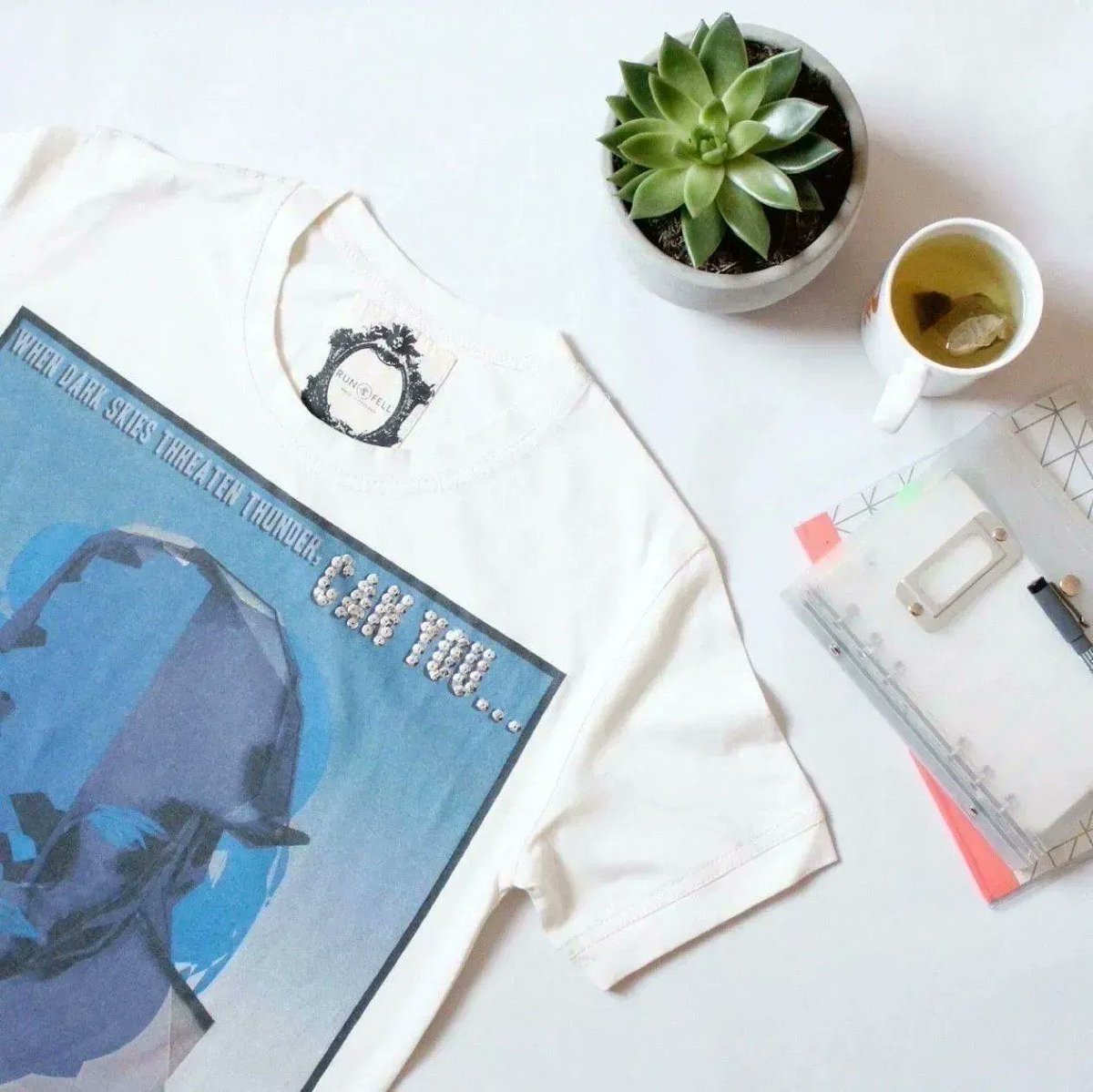 This T-shirt design was inspired by #vintage movie posters  and the work of graphic artist #AbramGames.

It's hand-embellished with antique French metal sequins... pretty special. The fabric is a rich, sumptuous #Organic Cotton jersey.

Click here: buff.ly/2RAArF0