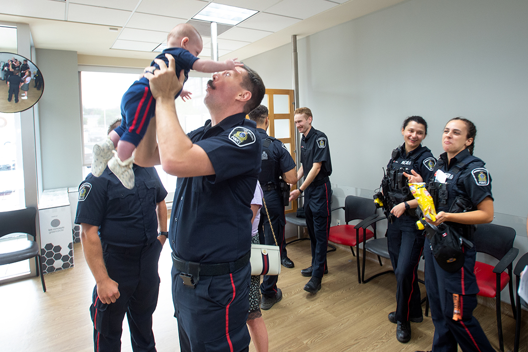 Waterloo Regional Police Service Const. Karl Dovick plays with his son, Jack, at the Canada Blood Services donation centre in Waterloo, Tuesday, August 8, 2024. Dovick’s daughter, Autumn, recently passed away from cancer and he asked colleagues to dontate blood in her memory.