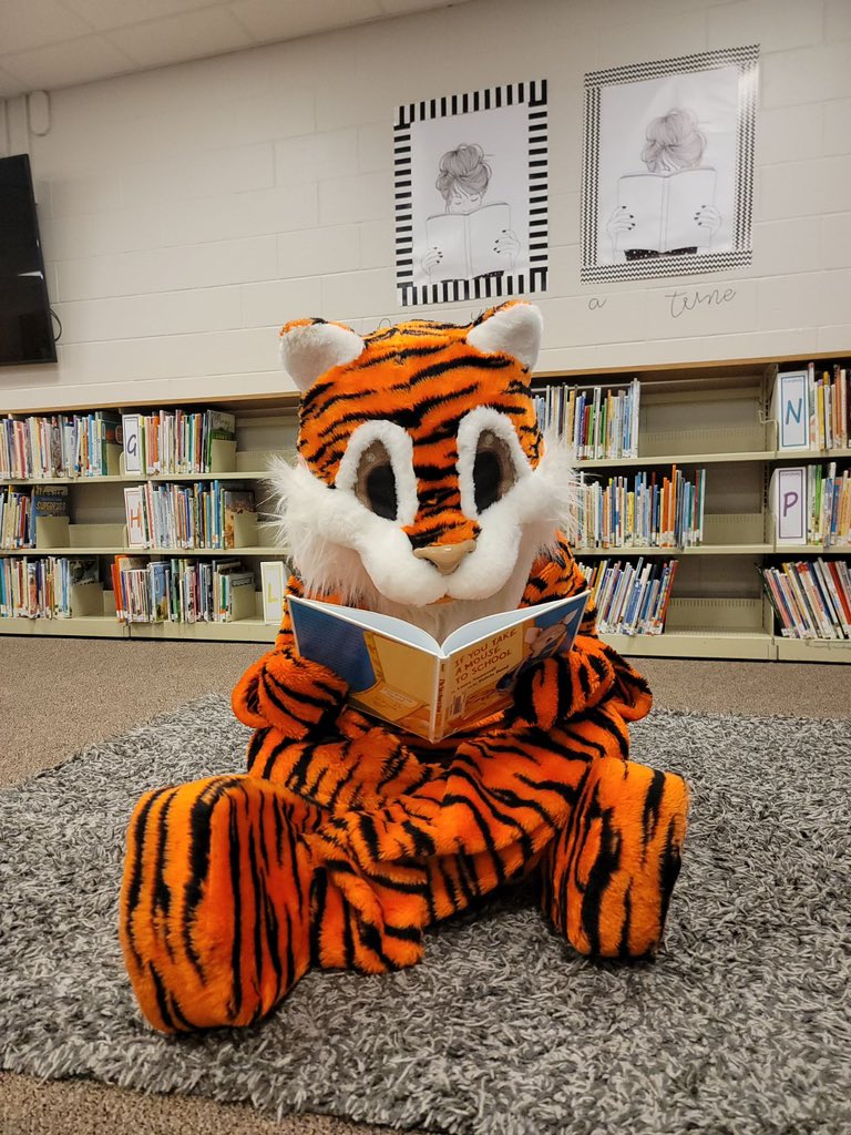Look who we already caught reading in the library-our mascot, Gilbert the Tiger! <a href="/hitchcock_mps/">Hitchcock Elementary</a>