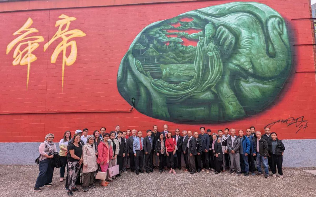 A photo of the community associations of Chinatown coming to support the unveiling of the new mural In Chinatown that showcases the Gee How Oak Tin association’s ancestor &amp; mascot who remind us to be benevolent community leaders and to care for one another. Mural by Alex Kwong