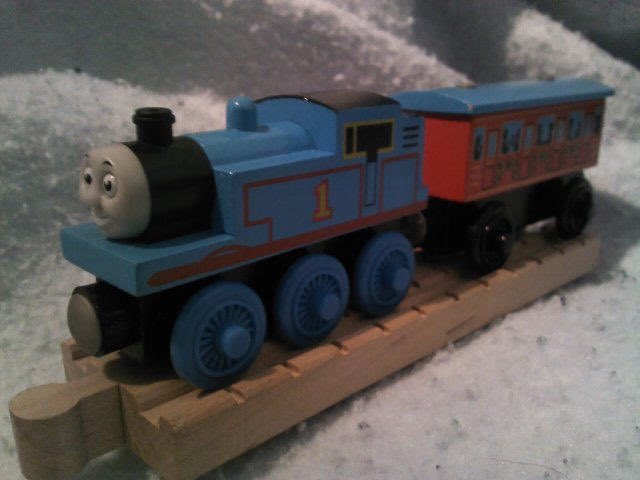 Tangent_Thomas's tweet image. Proof of concept prototype Thomas engine for the Wooden Railway 10 Years in America pack. 

This Thomas is identical to a normal 1999 release with mouth and eye details painted on, similar to the one used for the product photos. The final release also had a plastic smokebox.