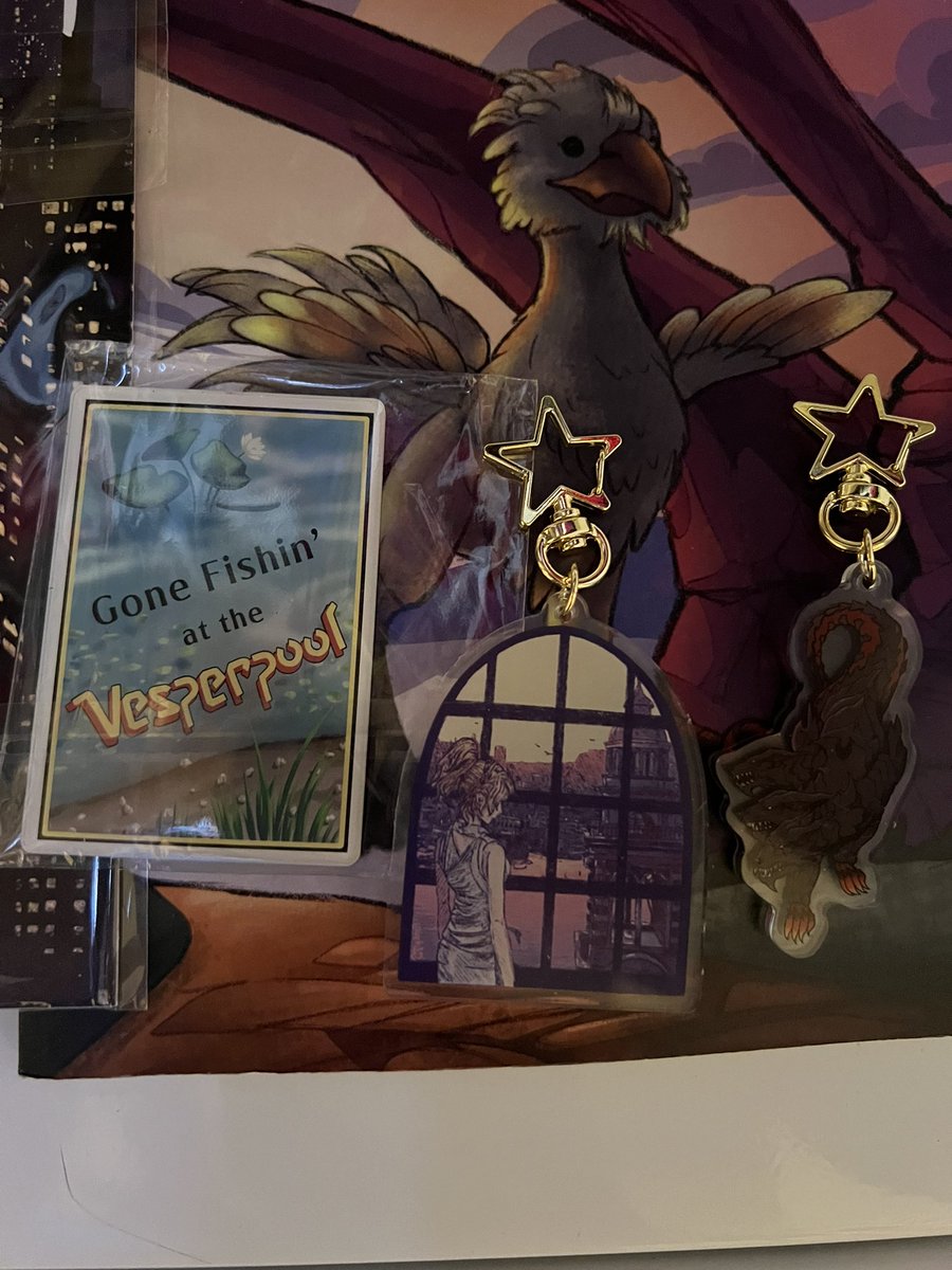 A closer look at some of the physical merch from <a href="/FFXVWanderlust/">Wanderlust: An FFXV Travel Zine</a> - these charms are going on my keys 😁