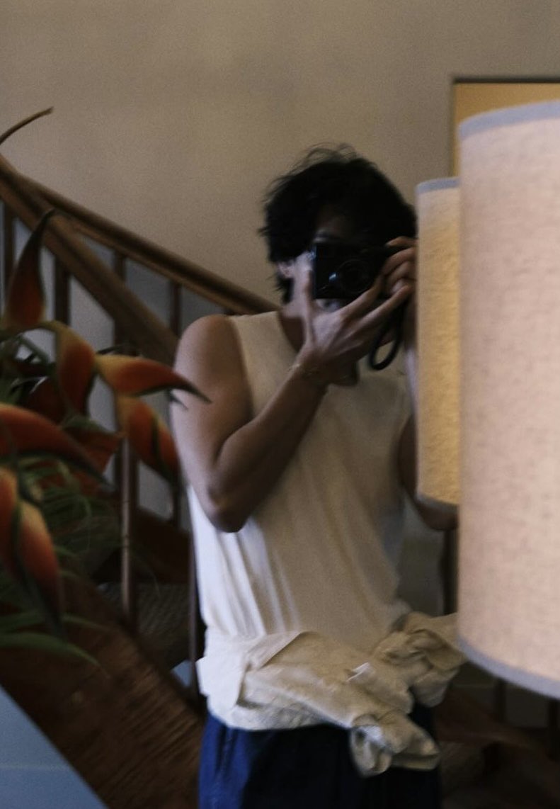 Blurred in a quick snap from my camera, I capture this cozy room in a relaxed tee and messy hair—honestly, it’s a perfect morning moment of laid-back vibes.