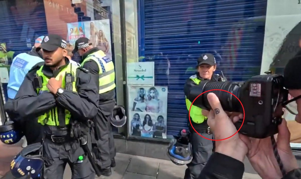 Leftwant2bRight's tweet photo. Some so call geezer as part of some press, with an interesting, if not strange symbol on his thumb which appears to be an Anarchist symbol at the #HopeNotHate TUC/SWP #Twafa protest in #Newcastle https://t.co/mcpa0eSnRN