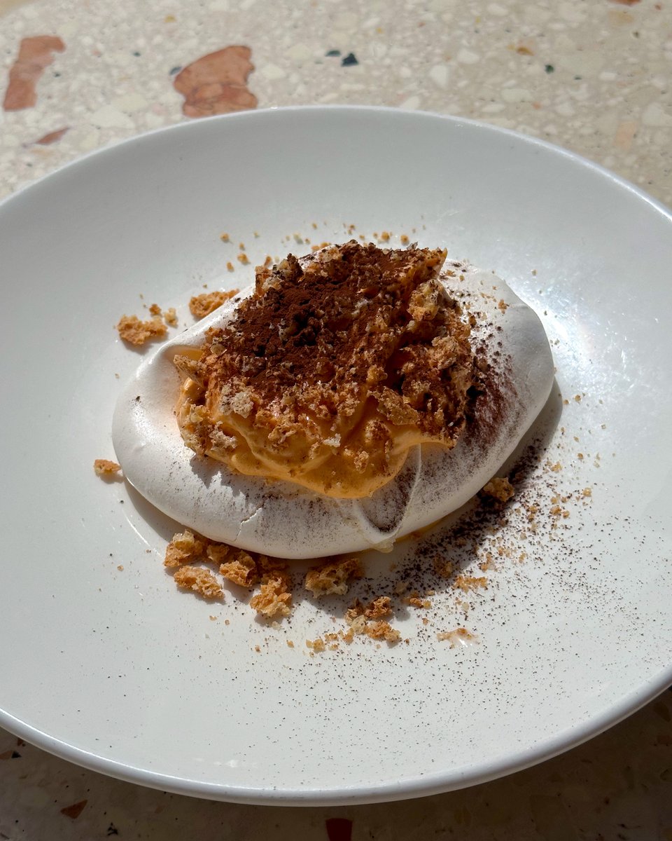 We make our meringues the Italian way, whisking sugar syrup until creamy, then slowly combining with egg whites to form soft peaks.

Crack through, scoop some of the zabaione cream, cocoa and crushed almonds.