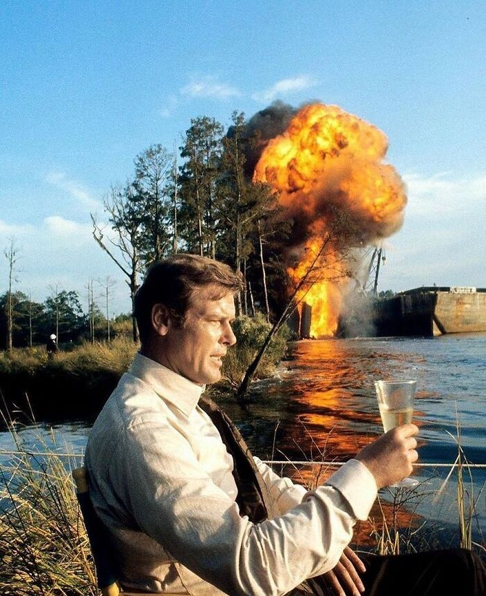 Roger Moore having a drink during the filming of 'Live and Let Die' (1973)